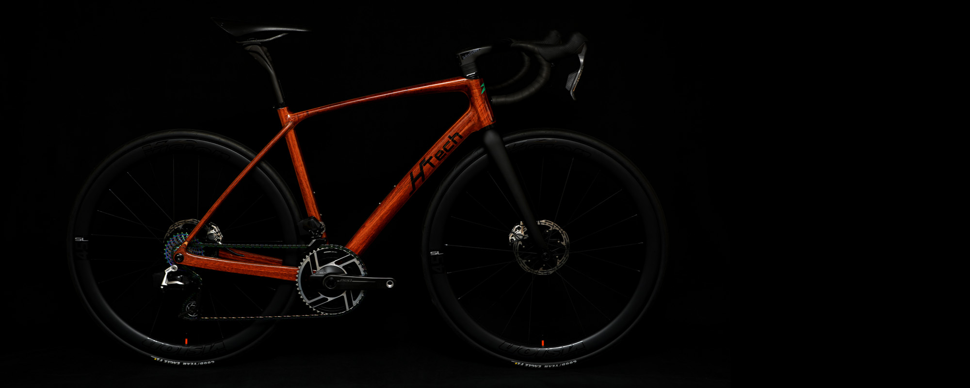 Jarrah HTech Aeriform with SRAM Red E1, Vision Metron wheels and cockpit, on dark background highlighting the wooden frame, Large Image