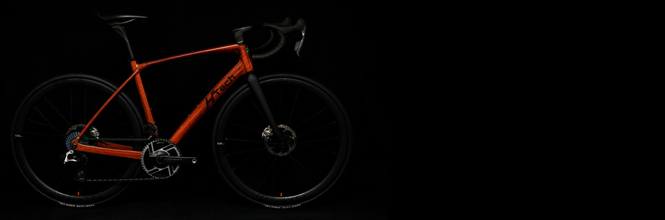 Jarrah HTech Aeriform with SRAM Red E1, Vision Metron wheels and cockpit, on dark background highlighting the wooden frame, Medium Image