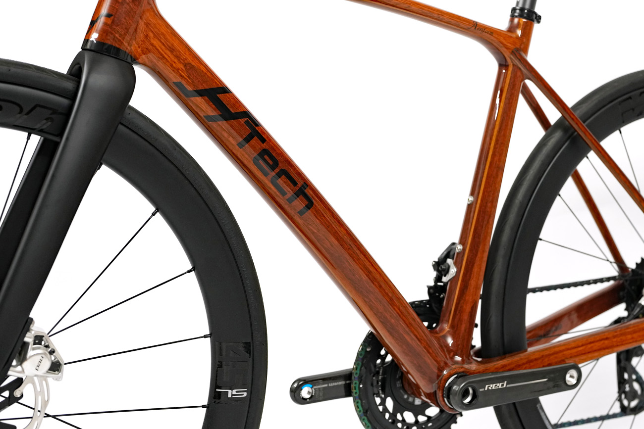 The down tube of a HTech Aeriform made from Jarrah, fitted with SRAM Red E1 and Vision Metron 45SL wheels