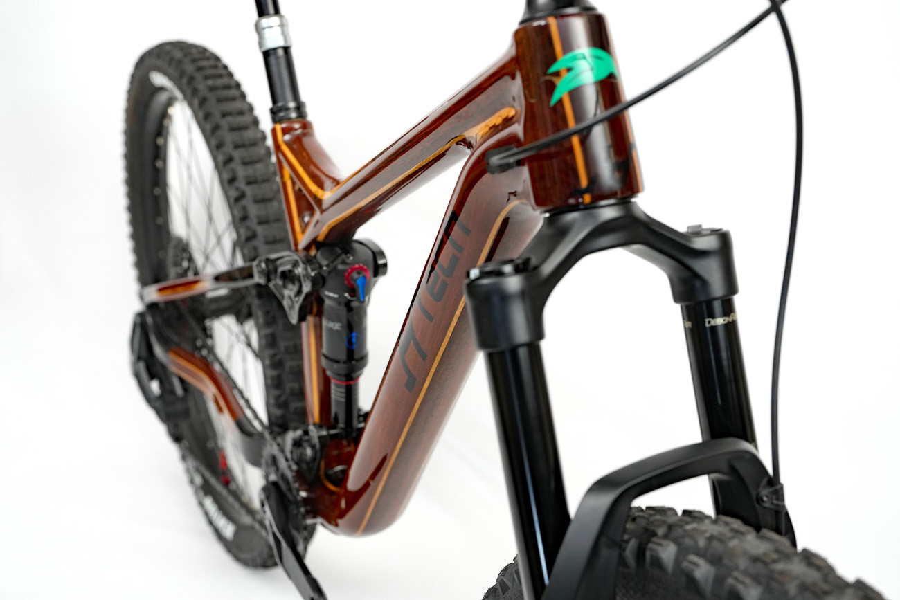 Reflections on high gloss finish of custom HTech Jarrah wooden mountain bike with Blackbutt stripe